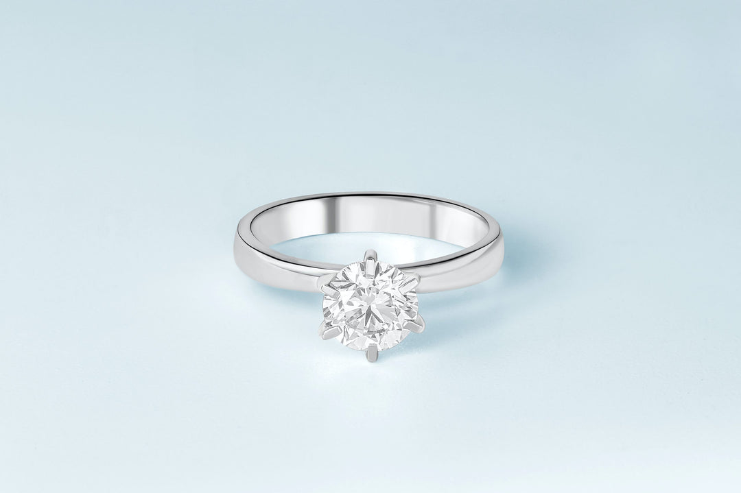 round solitaire engagement ring, light blue background
