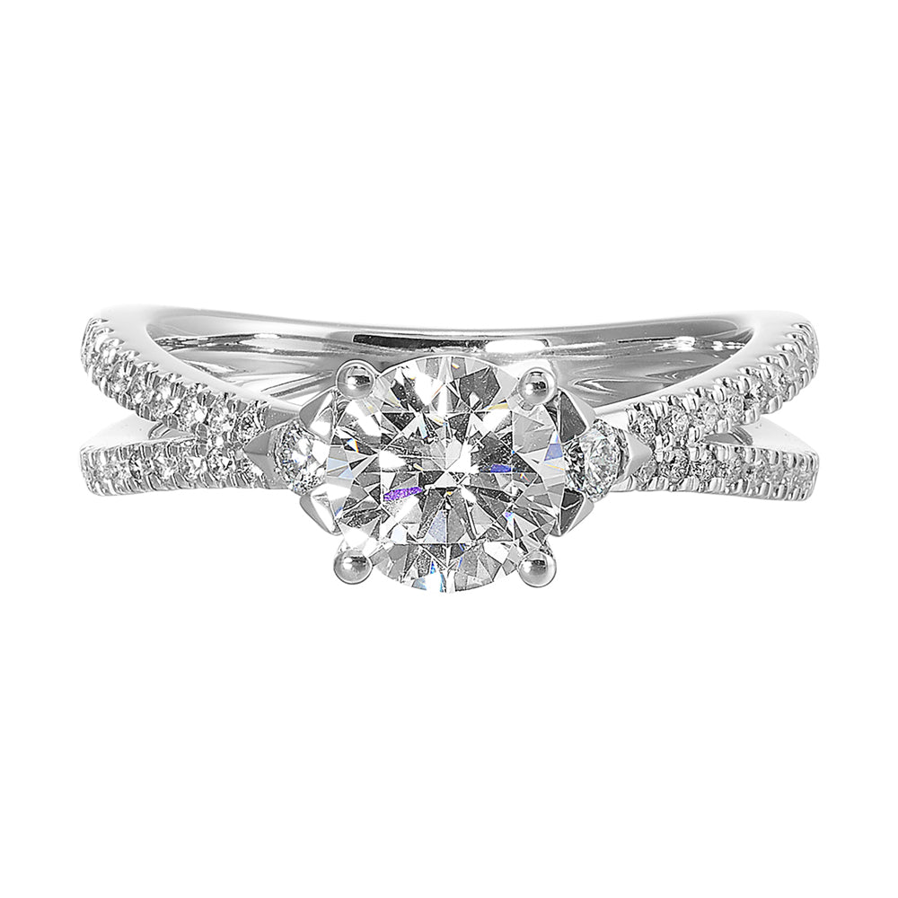 A split shank featuring two rows of diamond,  sitting pretty right on top is the round solitare,  with one round diamond on each side is sure a stunner.