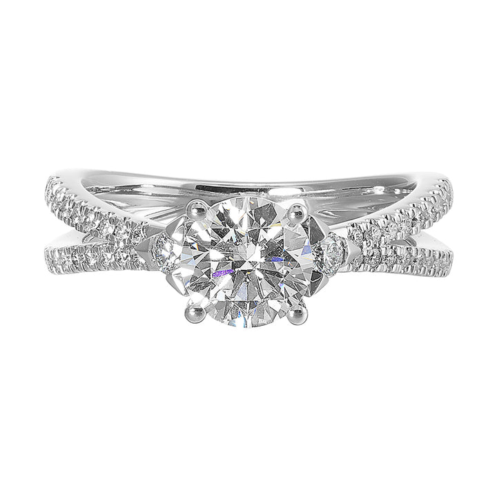 A split shank featuring two rows of diamond, sitting pretty right on top is the round solitare, with one round diamond on each side is sure a stunner.