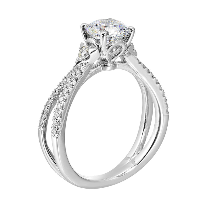 A split shank featuring two rows of diamond, sitting pretty right on top is the round solitare, with one round diamond on each side is sure a stunner.