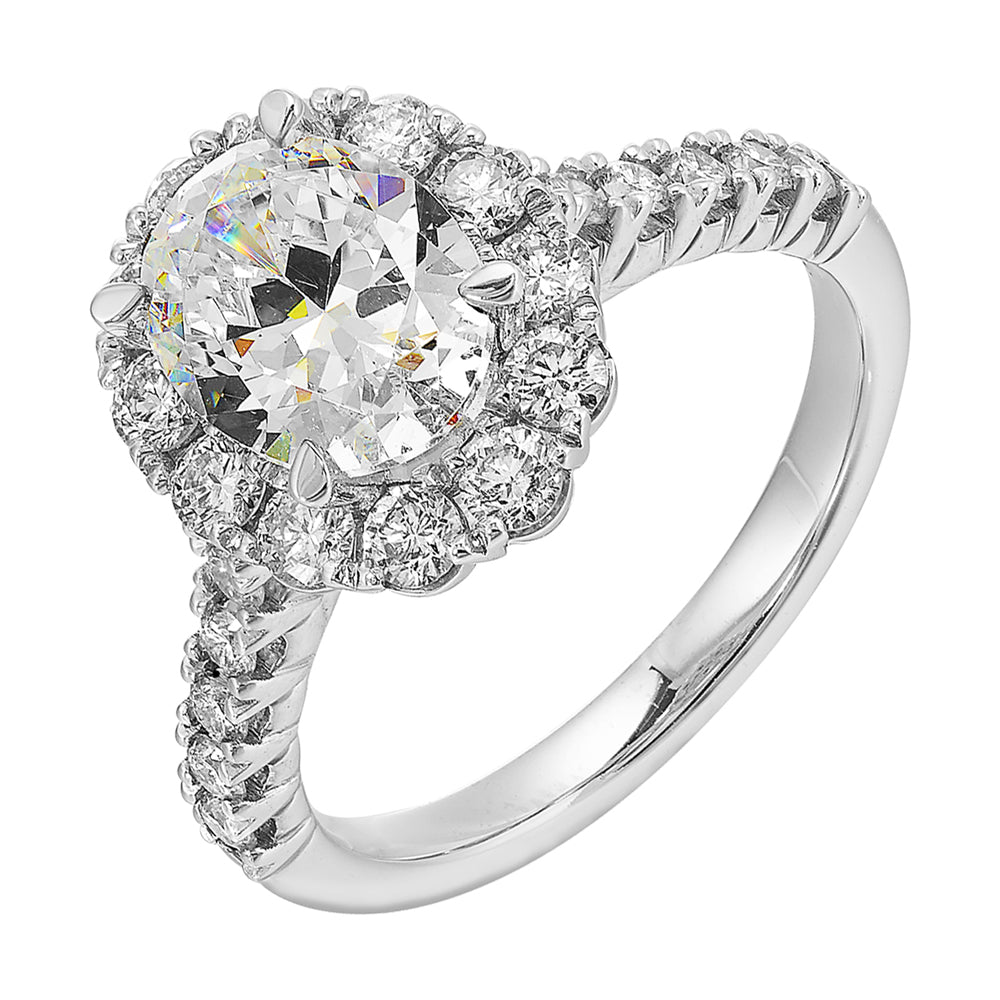 Featuring a mesmerizing floral halo around the solitare diamond adorned with sparkling diamonds on the shank is perfect for the classic you.