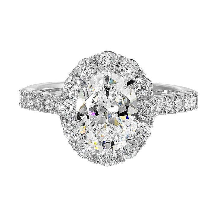Featuring a mesmerizing floral halo around the solitare diamond adorned with sparkling diamonds on the shank is perfect for the classic you.