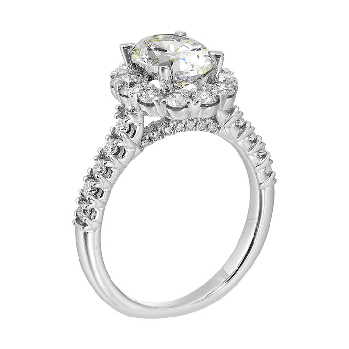Featuring a mesmerizing floral halo around the solitare diamond adorned with sparkling diamonds on the shank is perfect for the classic you.