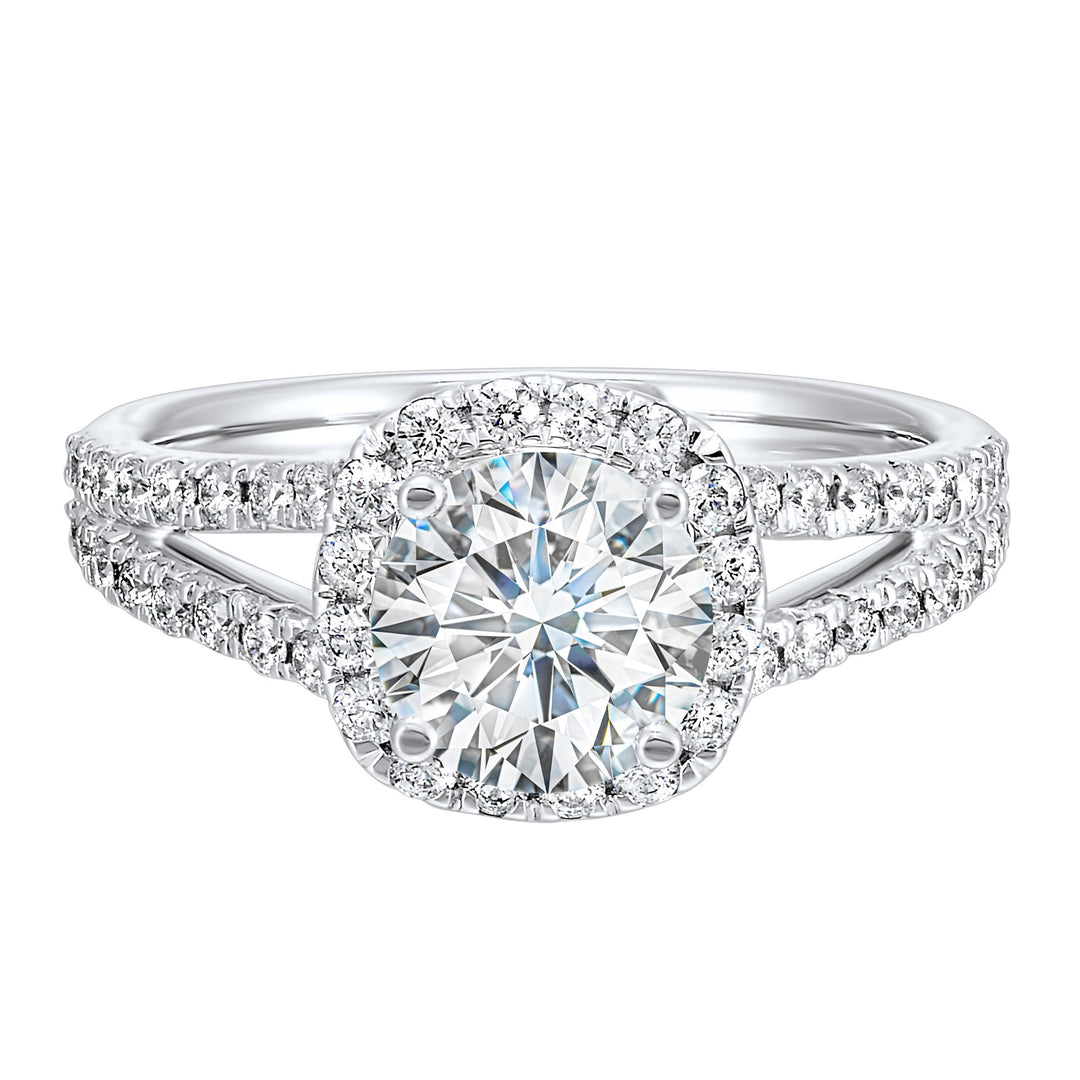 Cushion halo is a stunning way to showcase the round solitaire diamond. Modern split diamond studded shank further highlights the center.