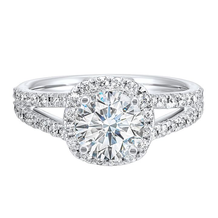 Cushion halo is a stunning way to showcase the round solitaire diamond. Modern split diamond studded shank further highlights the center.