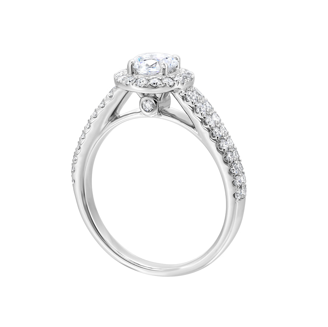 This beautiful engagement ring features pave set diamonds on the halo and a duet of diamonds gracefully embrace the tapered band highlighting the center solitare perfectly.