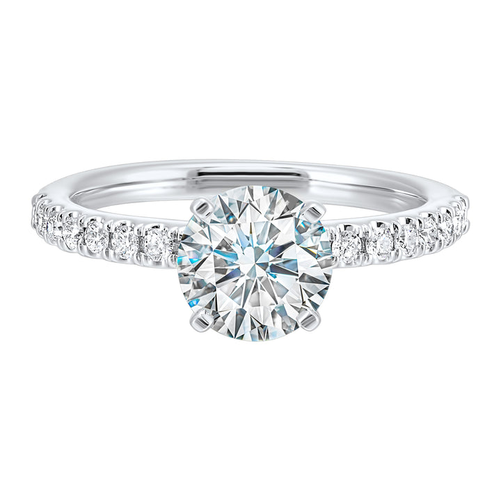 Classic and ready to make you shine, this ring features diamonds set in pave with a center solitaire.