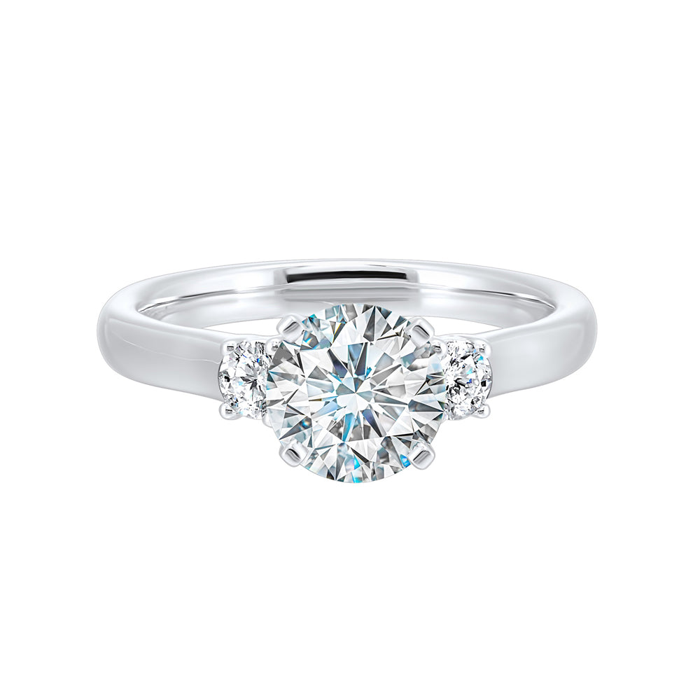 Classic and romantic,  this three stone engagement ring features the bold gold shank to sparkle your moments further.
