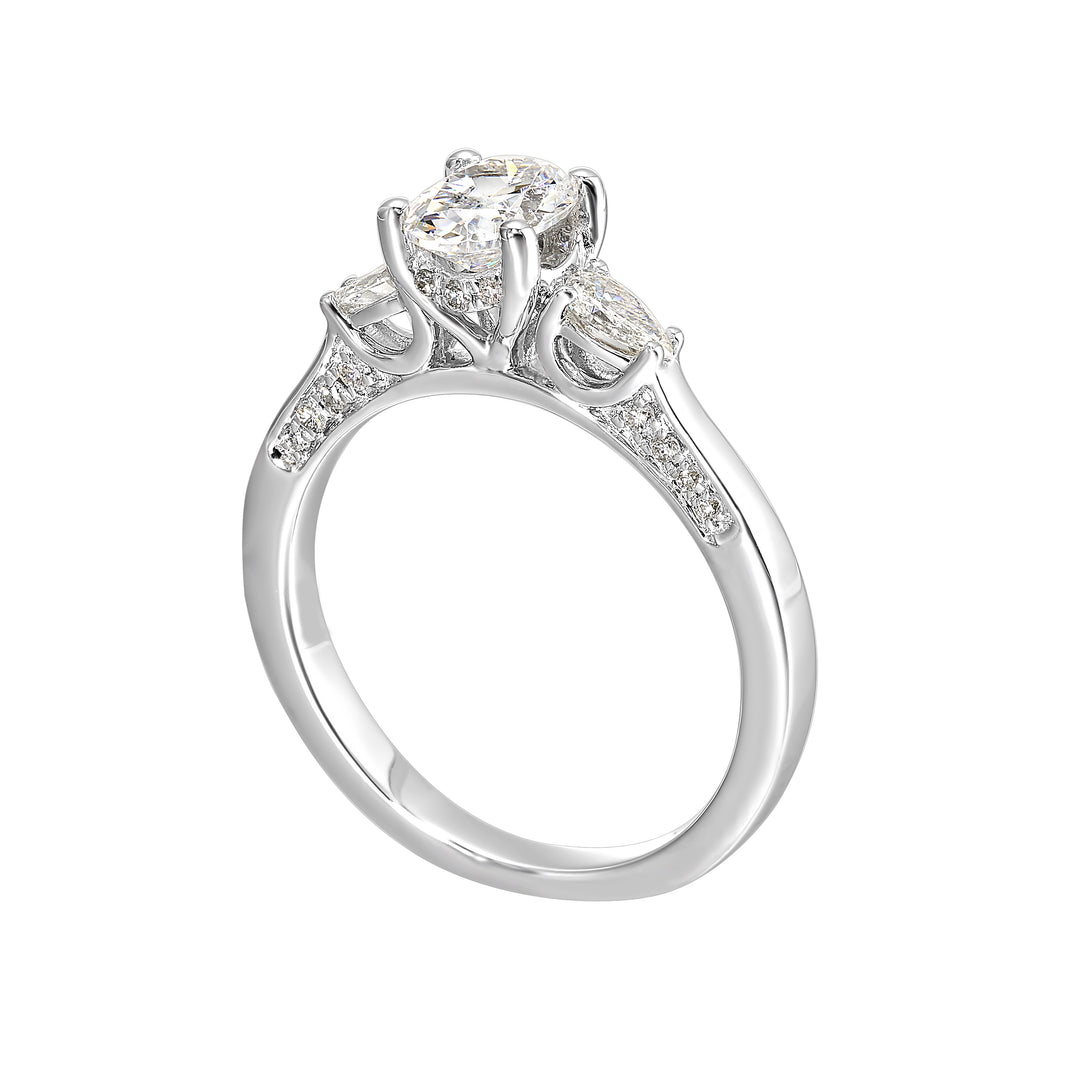Three stone ring features an oval cut solitare nestled inbetween pear cut diamond, all embellished with sparkling diamond accents in front.