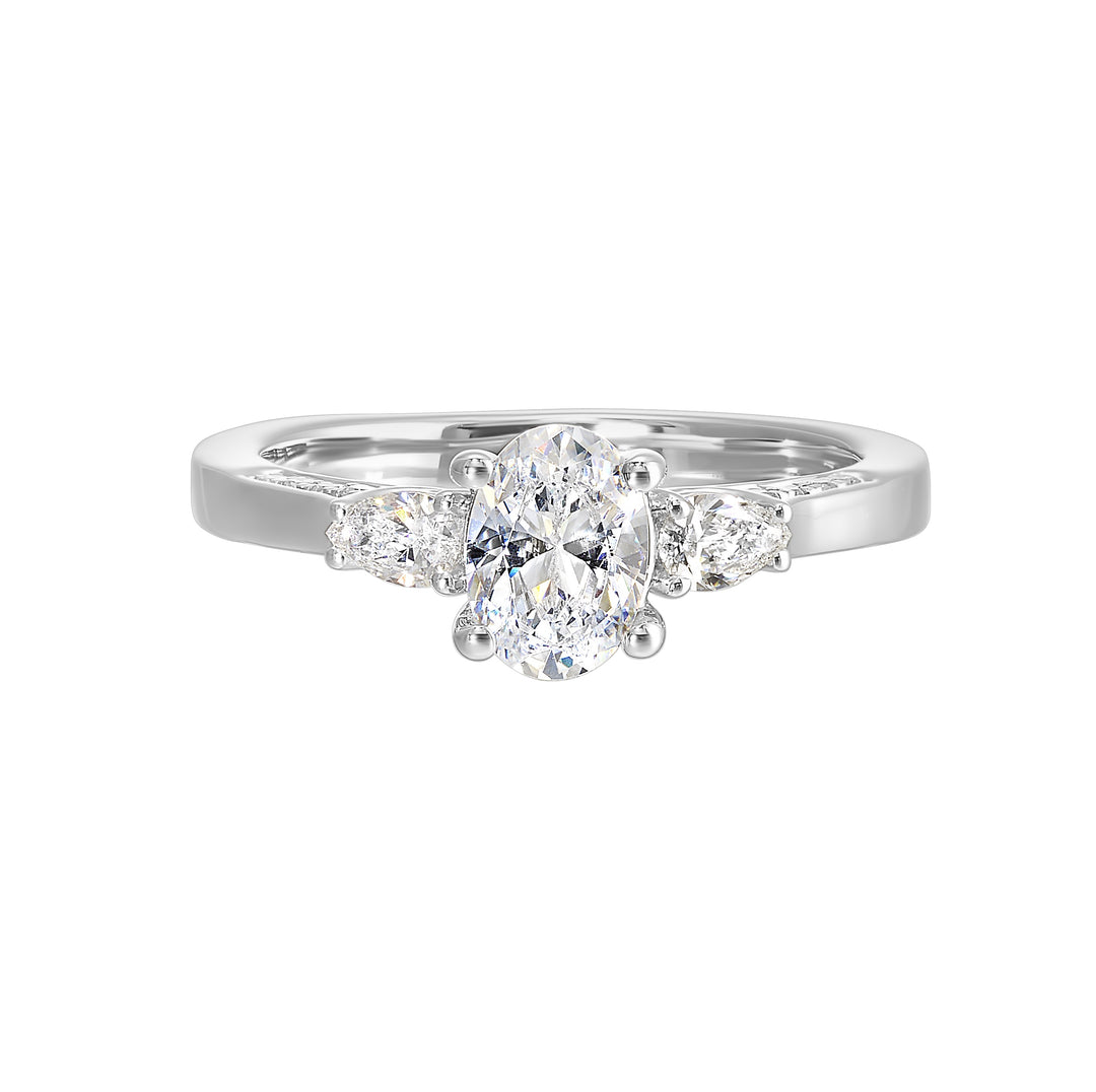 Three stone ring features an oval cut solitare nestled inbetween pear cut diamond,  all embellished with sparkling diamond accents in front.