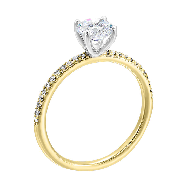 A solitaire ring features a delicate micro pave diamond shank, adding a touch of brilliance, is a timeless classic choice.
