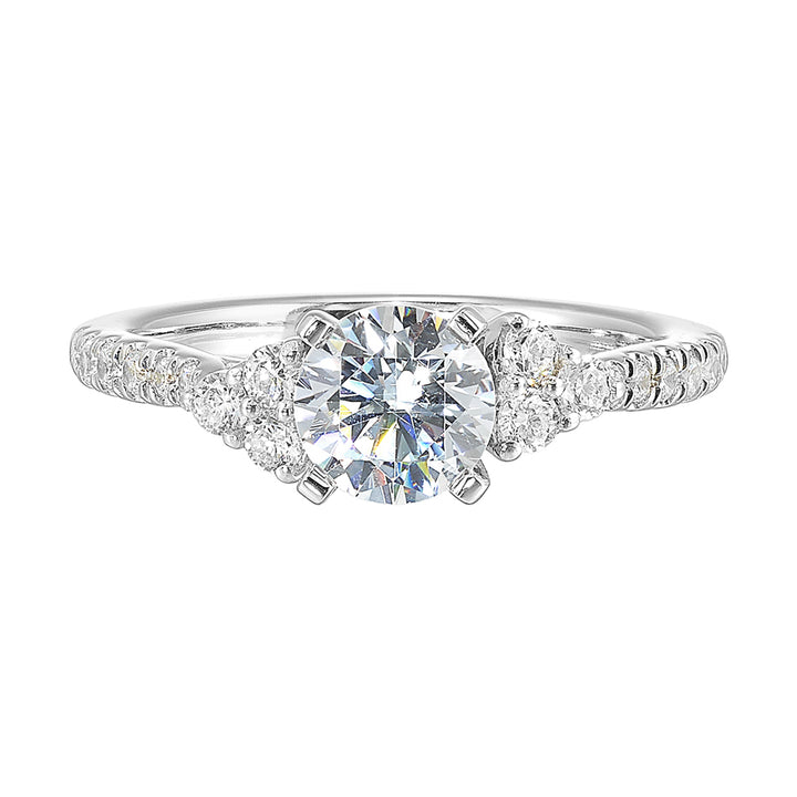 Three stone ring with a cluster of diamonds along the shoulder followed by a tapered diamond shank is sure to complement her.