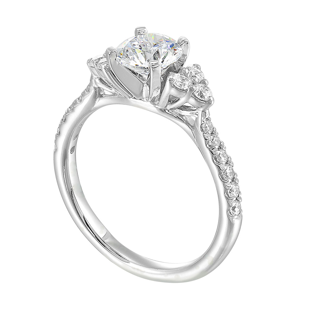 Three stone ring with a cluster of diamonds along the shoulder followed by a tapered diamond shank is sure to complement her.