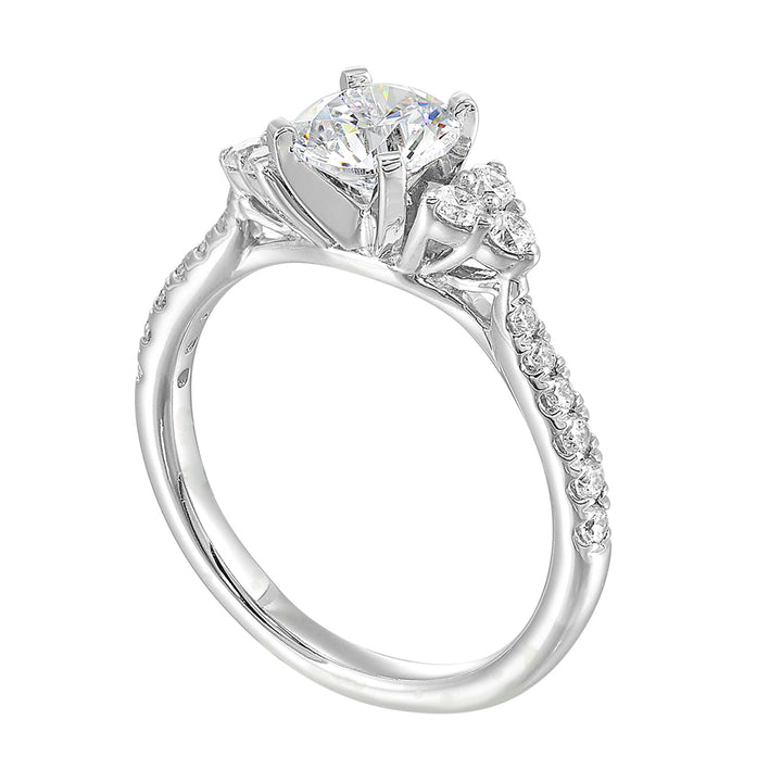Three stone ring with a cluster of diamonds along the shoulder followed by a tapered diamond shank is sure to complement her.
