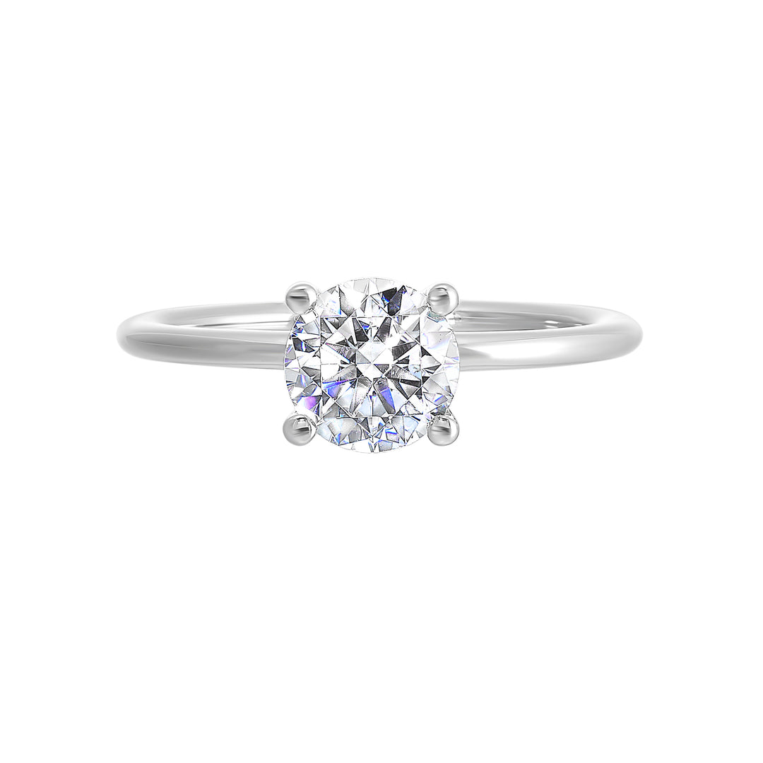 Classic four prong solitaire engagement ring with a petite band adds to the sleek, classic look of the design.