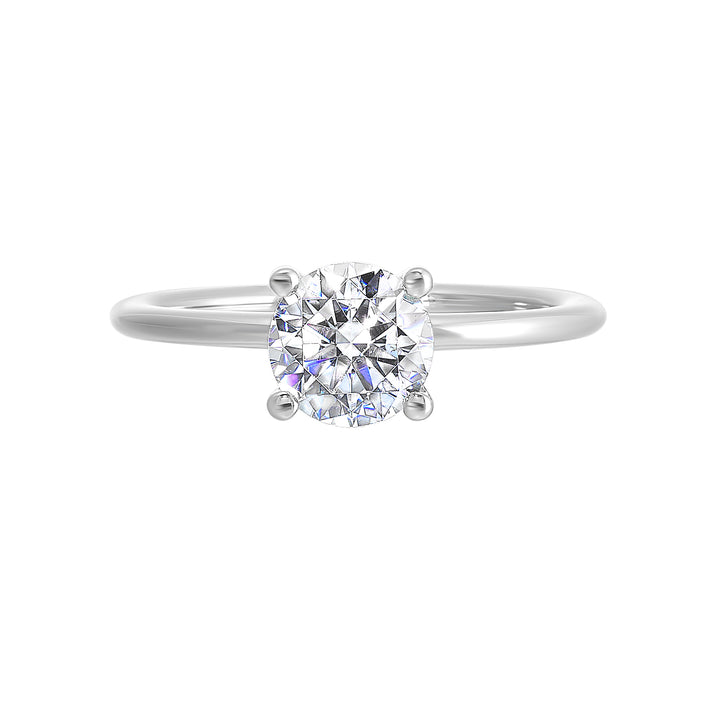 Classic four prong solitaire engagement ring with a petite band adds to the sleek, classic look of the design.