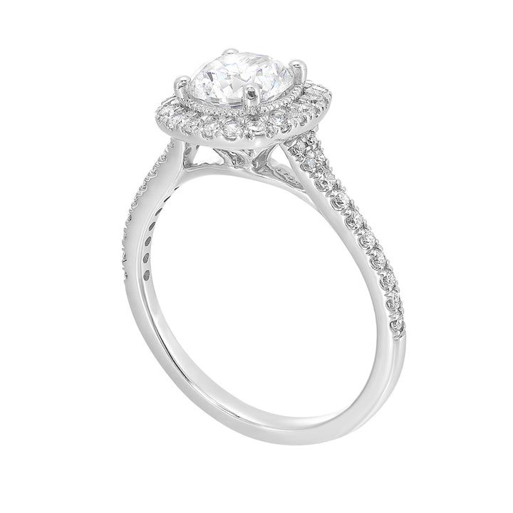 Sparkling cushion halo features beautiful set pav? diamonds that encircle the center solitare and adorn the band.
