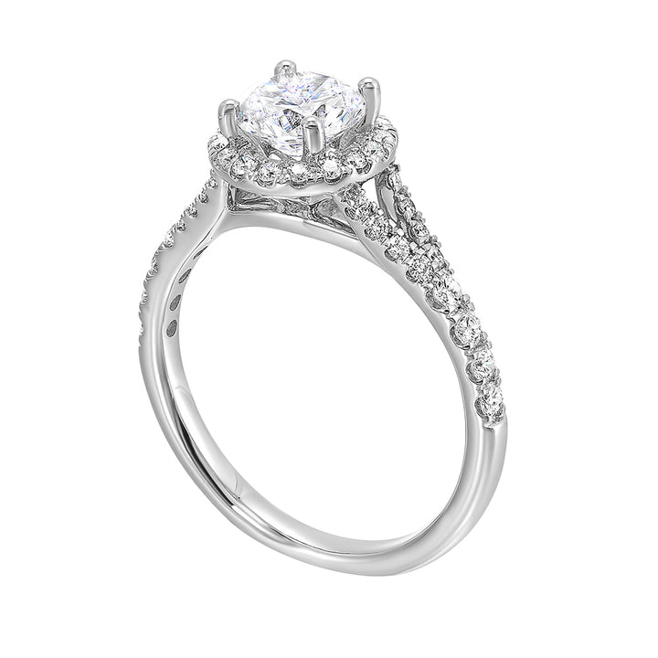 This ring stuns with a round solitaire embraced by a halo and a delicate split shank. Its a unique symbol of your love story.