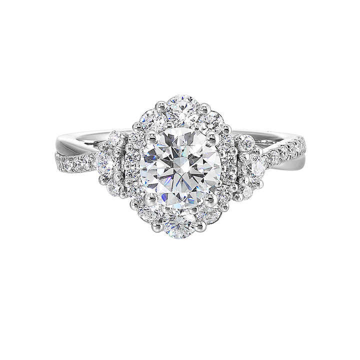 A mesmerizing oval halo ring with graduating diamonds and half moon diamond cluster on either side adds a touch of brilliance and elegance with twisted shank.