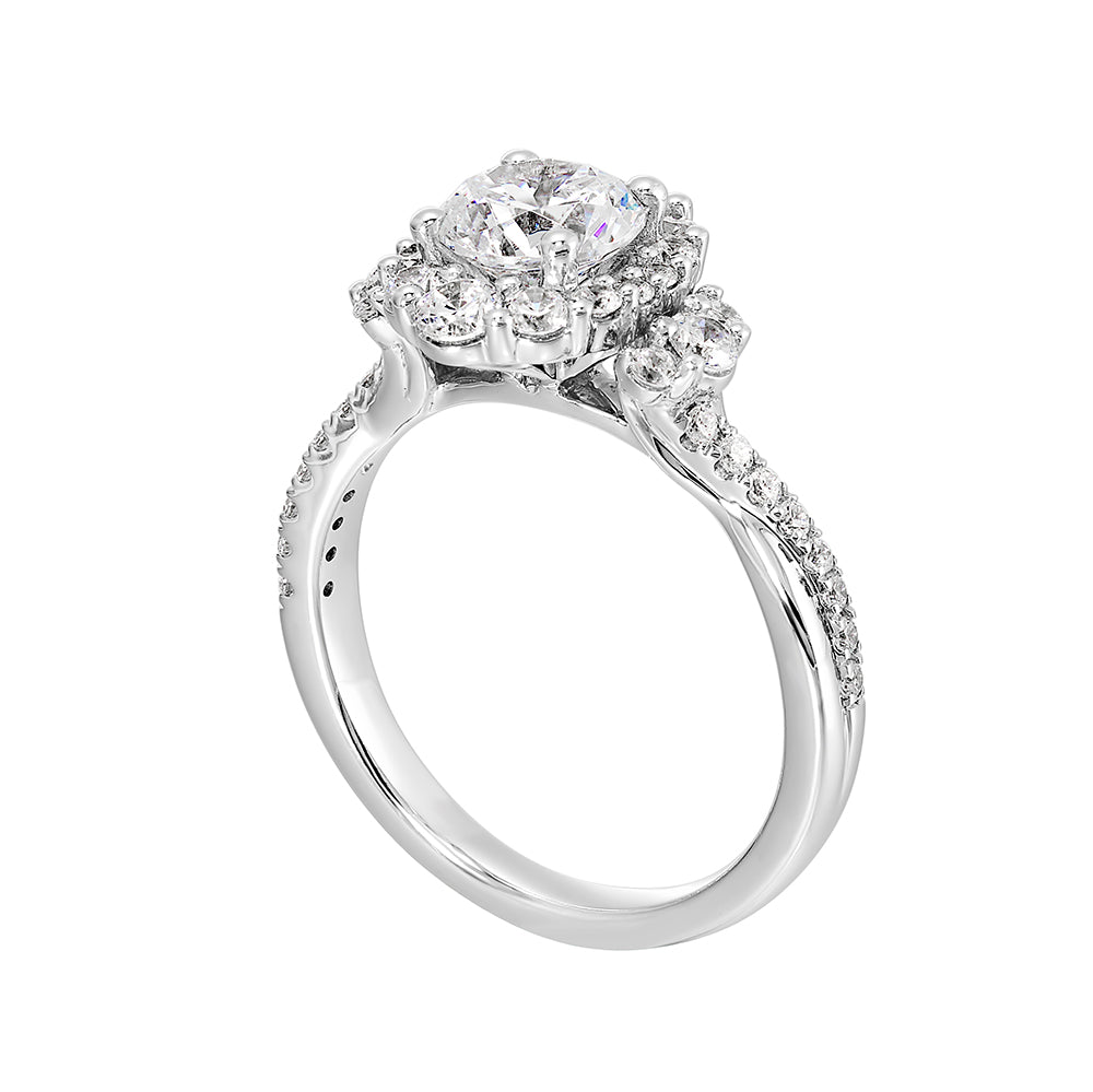 A mesmerizing oval halo ring with graduating diamonds and half moon diamond cluster on either side adds a touch of brilliance and elegance with twisted shank.