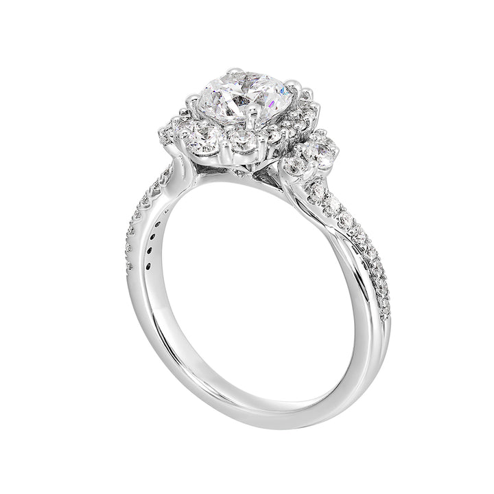A mesmerizing oval halo ring with graduating diamonds and half moon diamond cluster on either side adds a touch of brilliance and elegance with twisted shank.