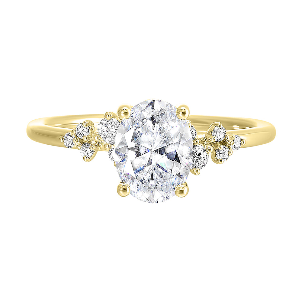 This simply gorgeous engagement ring with oval center features a sleek gold band with floating diamonds on either sides in random placement coming together beautifully.