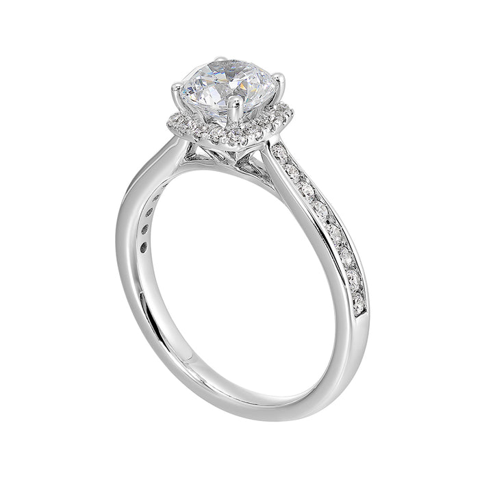 Cushion diamond halo engagement ring with a channel set diamond band is the perfect representation of high end elegance.