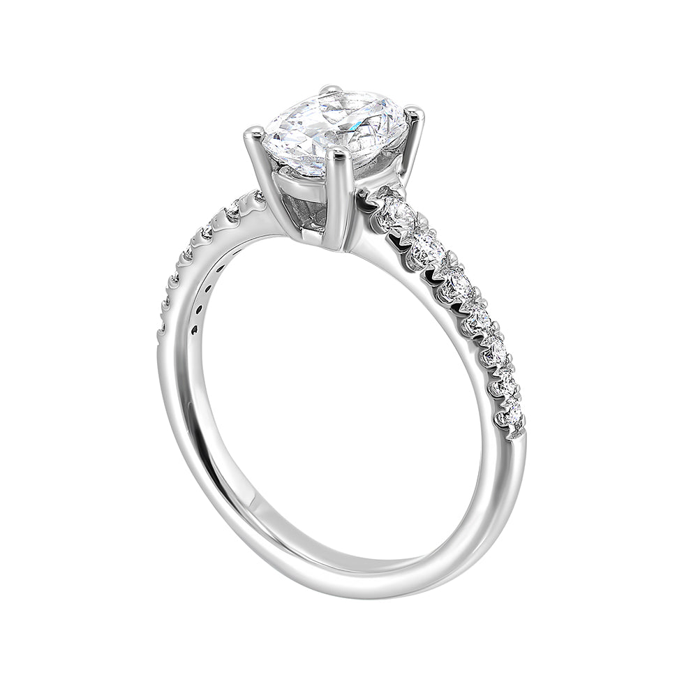 Defined by a tapered shank set with graduated round diamonds, this classic oval solitaire engagement ring gracefully compliments your look.