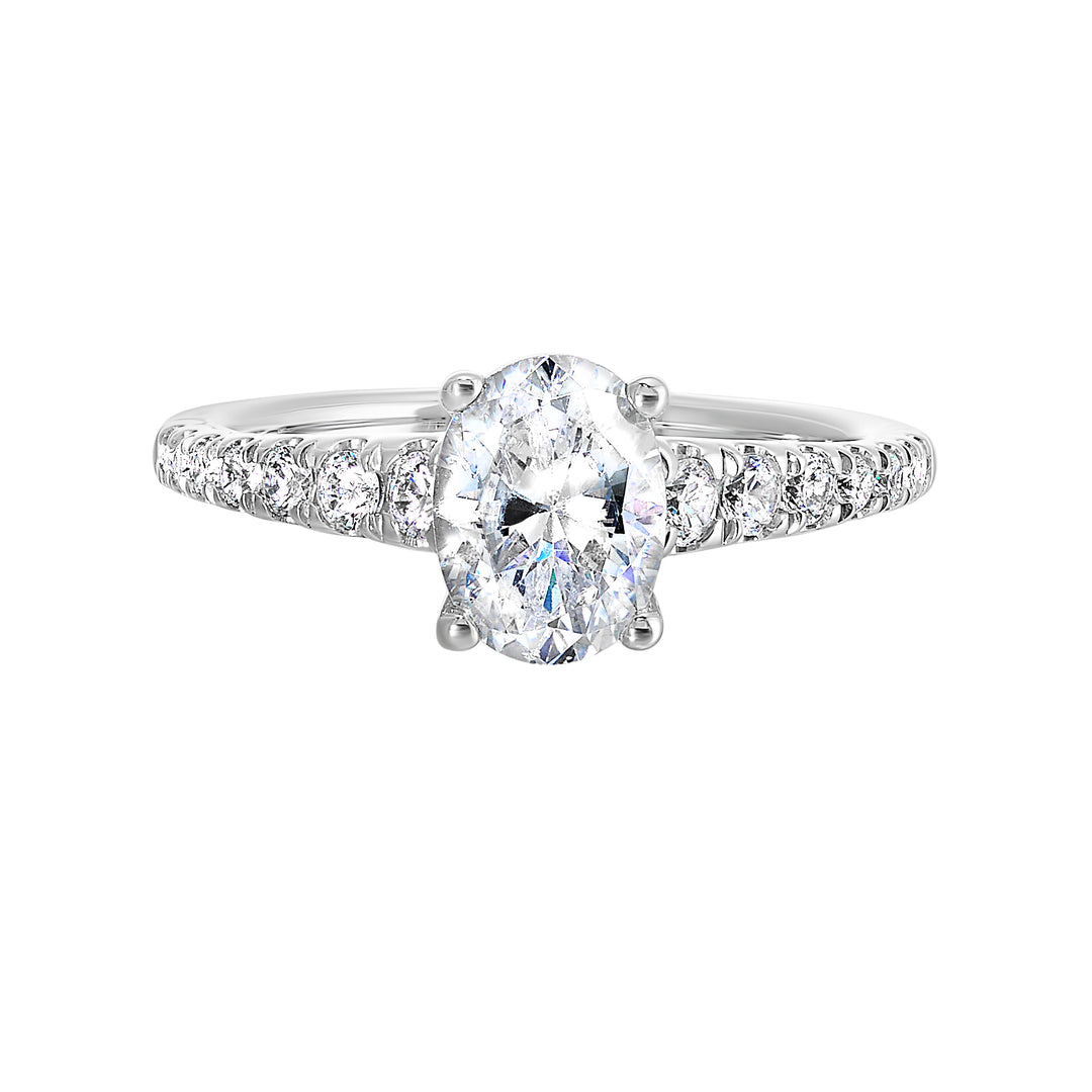 Defined by a tapered shank set with graduated round diamonds,  this classic oval solitaire engagement ring gracefully compliments your look.