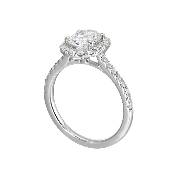 Oval solitaire halo ring with sleek diamond studded shank, this design offers a romantic look for your special moments.