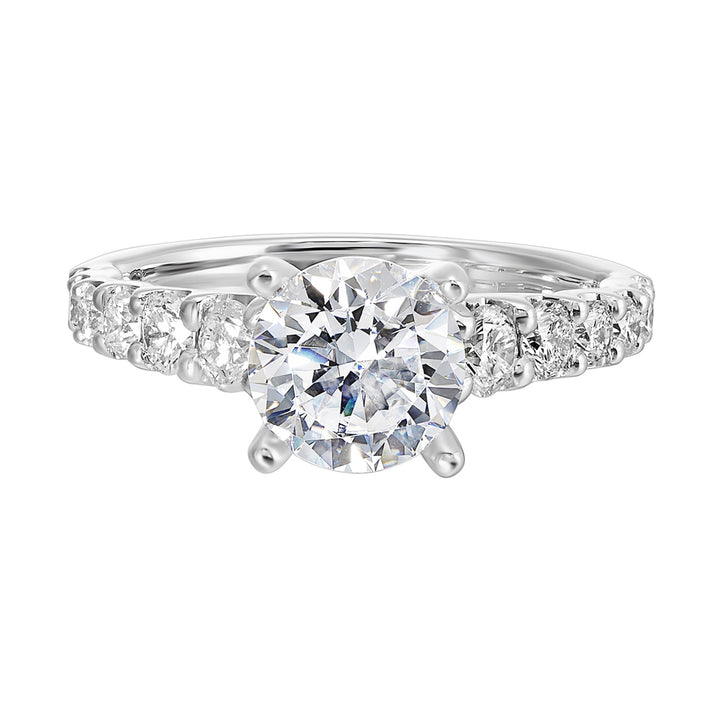 A classic round solitaire elevated by a graduating diamond shank set in common prong offers timeless elegance. Is perfect for your love story.