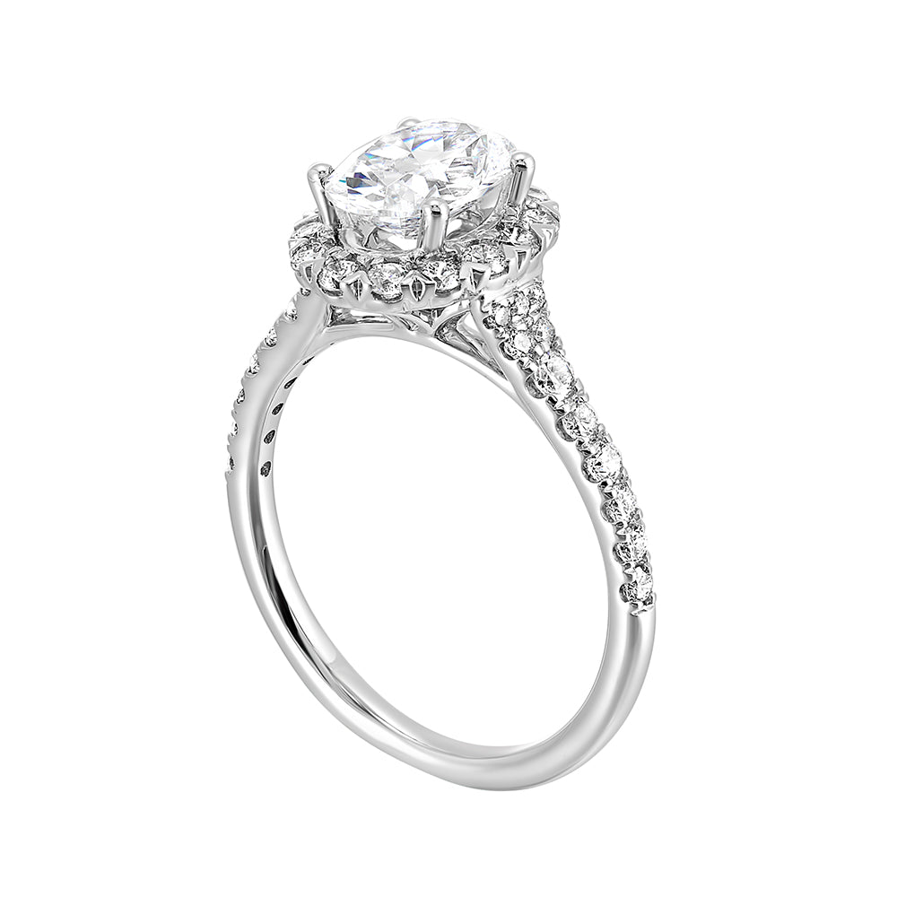 This breathtaking engagement ring combines classic and modern styles with a dazzling oval center and halo followed by a tapered shank look.