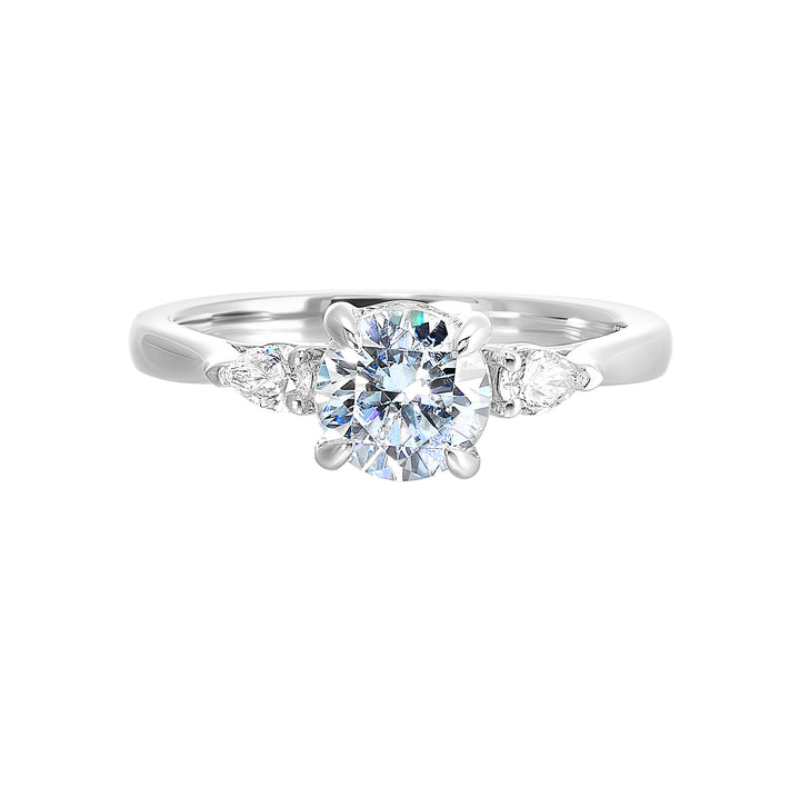 Captivating pear shaped diamonds frame the center solitare in this classic three stone ring with hidden diamond accent in front.