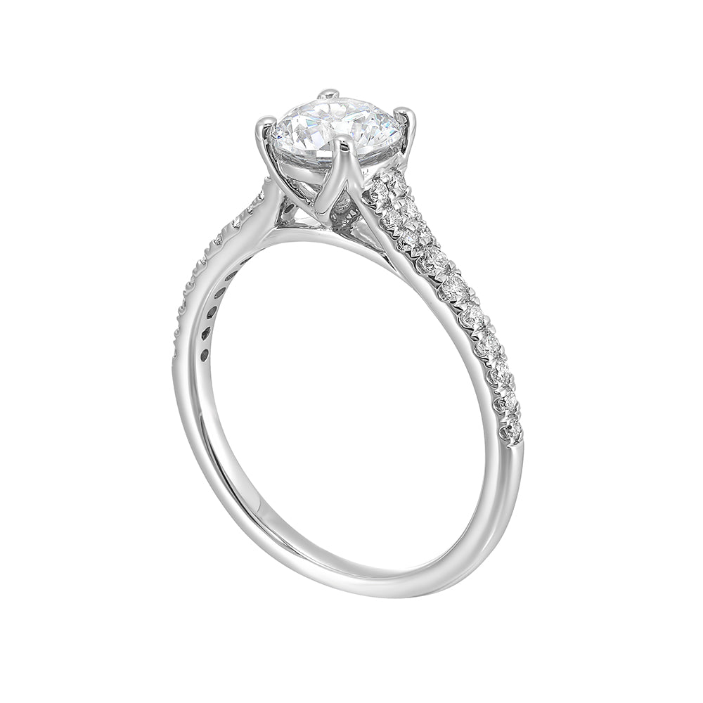 Defined by a tapered shank set with graduated round diamonds, this classic solitaire engagement ring is a classy choice