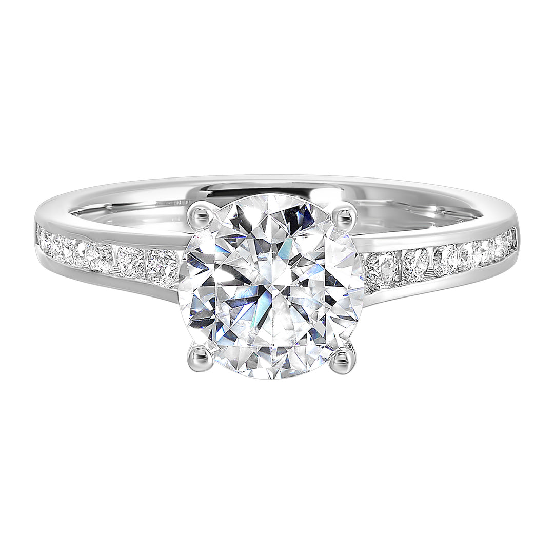 The simplicity of this single row channel set diamond shank engagement ring with four prong solitaire is simply gorgeous.