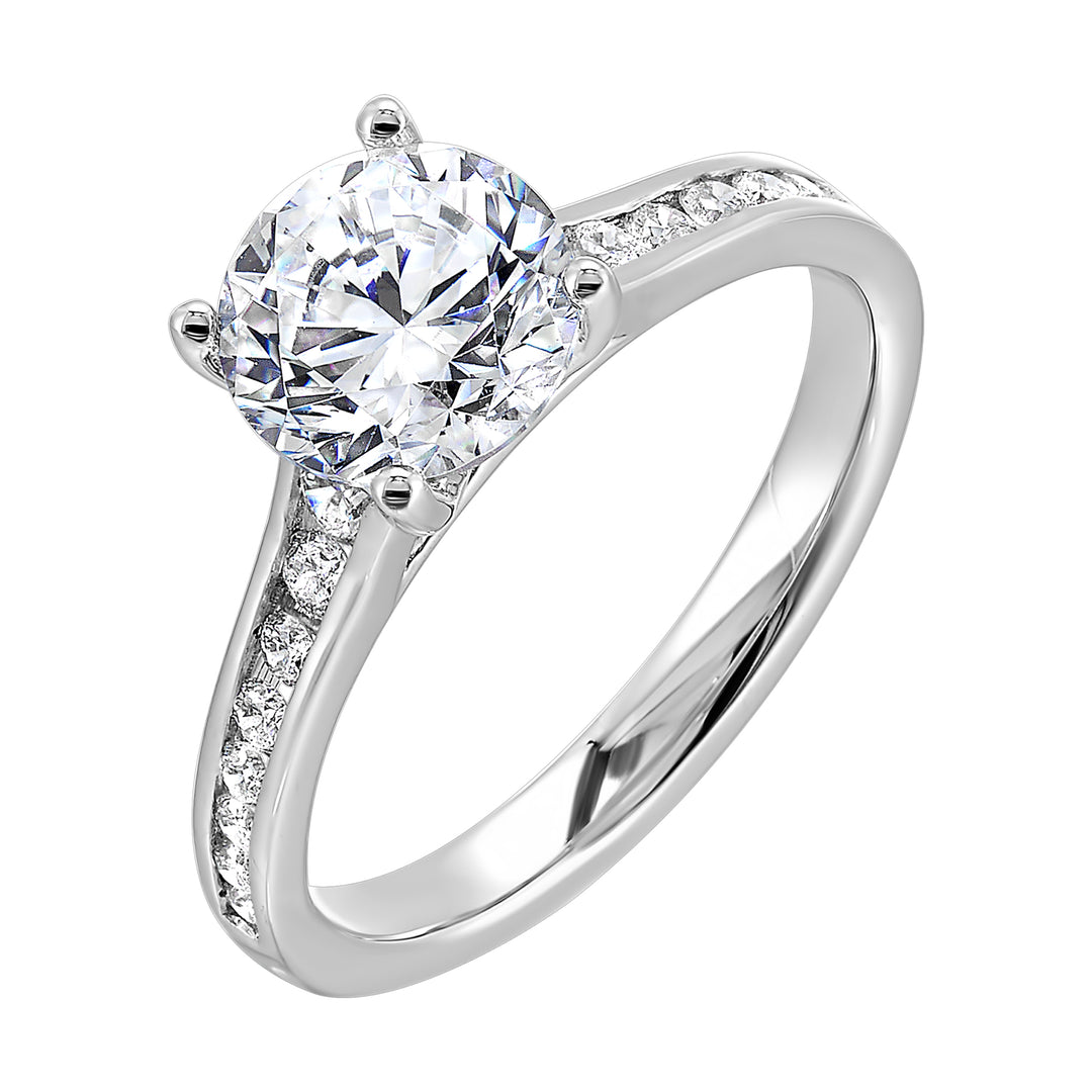 The simplicity of this single row channel set diamond shank engagement ring with four prong solitaire is simply gorgeous.