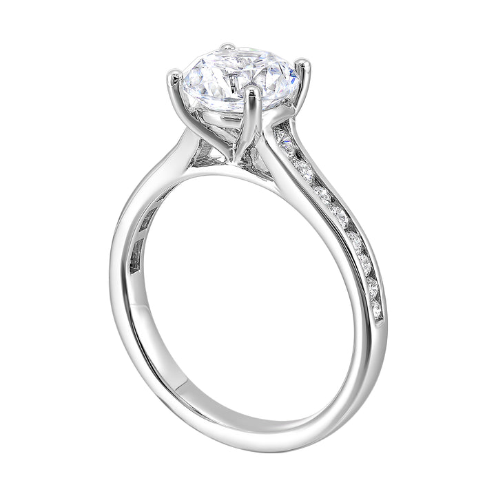 The simplicity of this single row channel set diamond shank engagement ring with four prong solitaire is simply gorgeous.