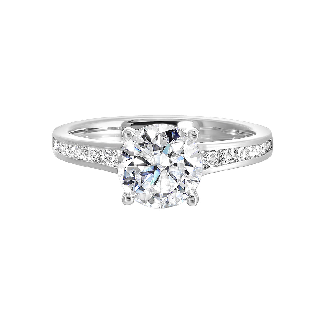 The simplicity of this single row channel set diamond shank engagement ring with four prong solitaire is simply gorgeous.