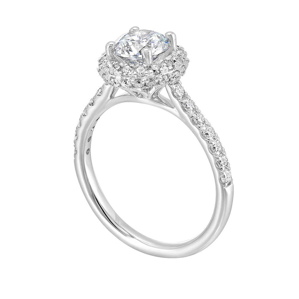 Sparkling center showcases a stunning halo followed by a delicate micro pave shank, perfect to add sparkles to your evening.