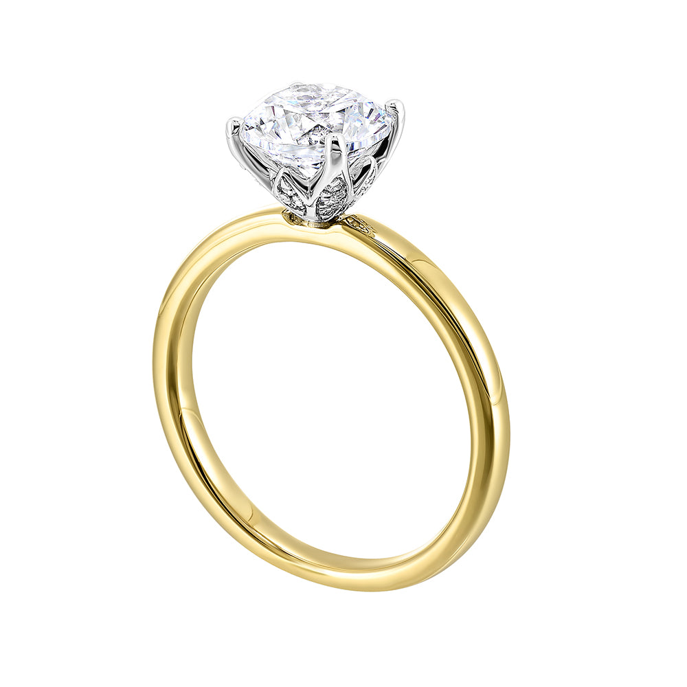Engraved details flow towards a brilliant center solitare in this modern engagement ring.