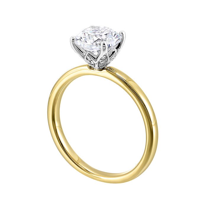 Engraved details flow towards a brilliant center solitare in this modern engagement ring.