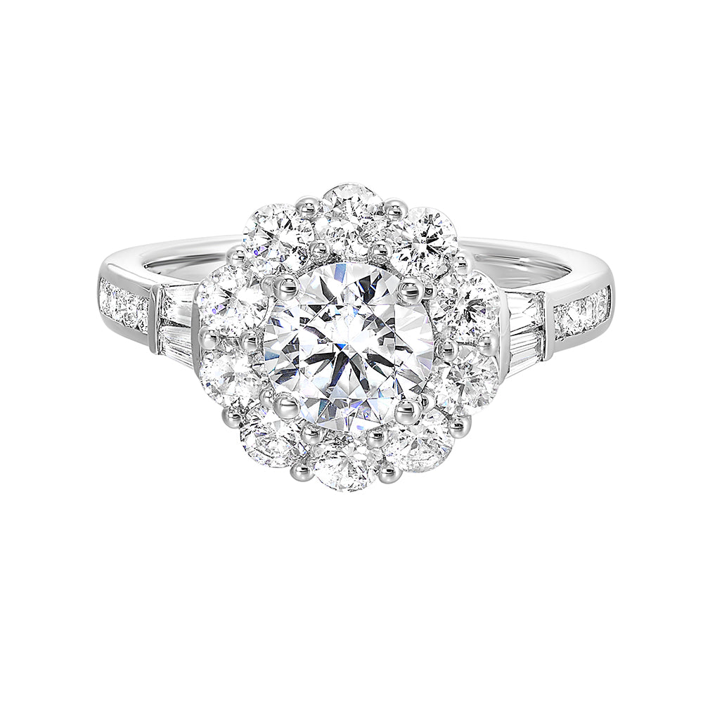 Elegant and romantic,  this engagement ring highlights a floral inspired halo followed by a tapered shank of baugette and round diamonds.