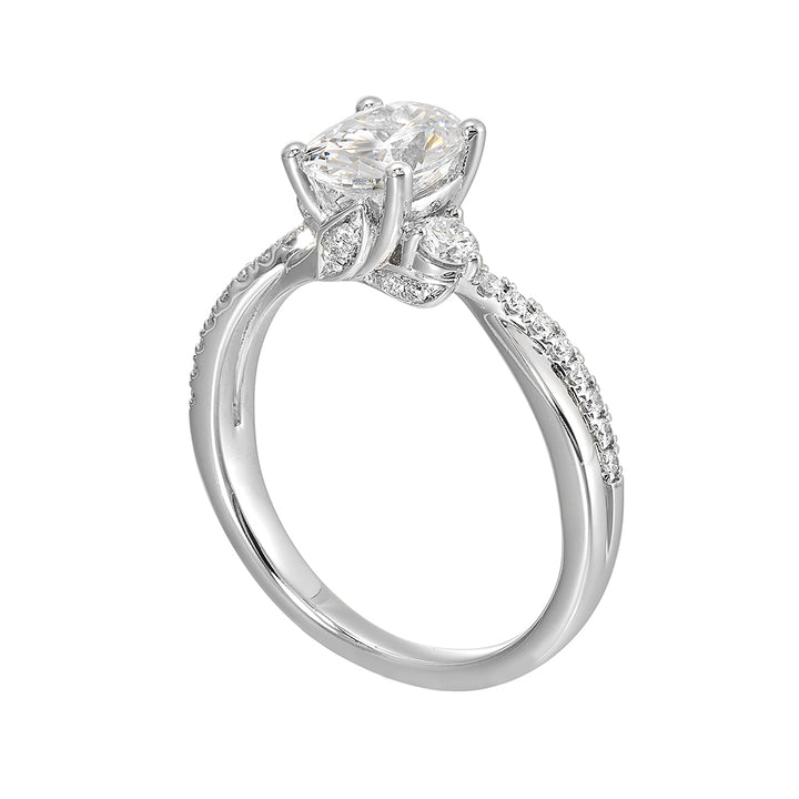 Glamorous three stone ring features curving bands with sparkling pave diamonds and metal forming a captivating details in front.