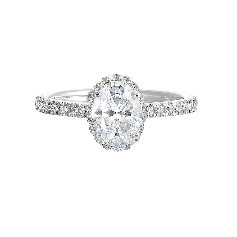 This stunning engagement ring features an oval solitare diamond,  accented by pave set round diamonds on shank and a hidden halo.