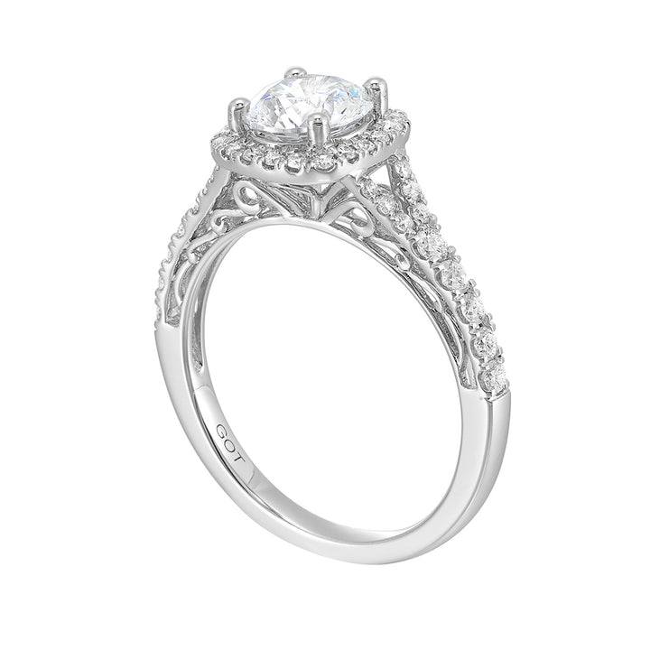 A softened cushion halo of diamonds surrounds the center solitaire with front details.Pave split shank adds a stylish, dazzling look.