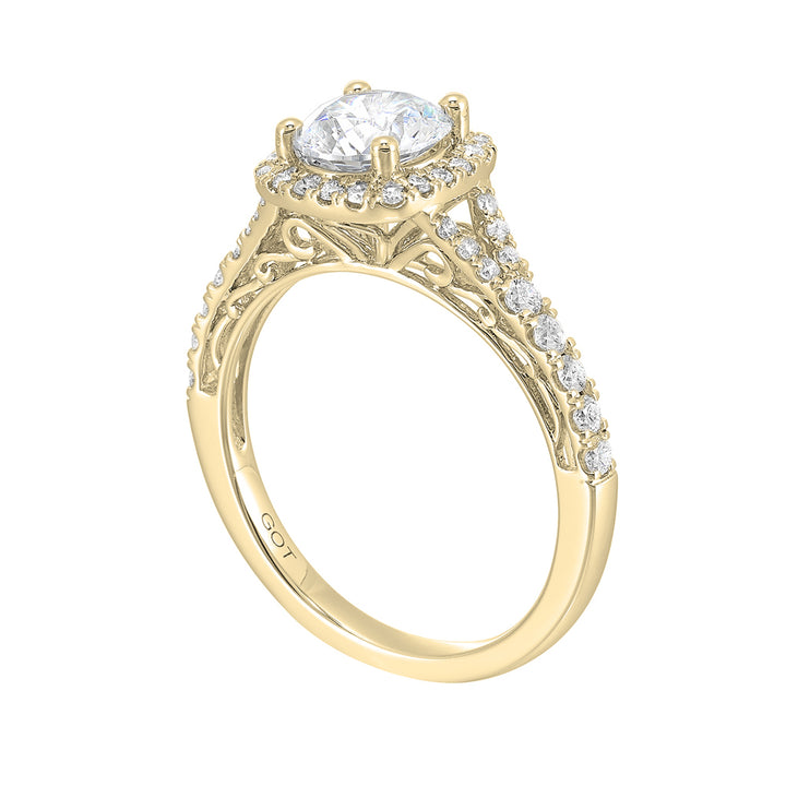 A softened cushion halo of diamonds surrounds the center solitaire with front details.Pave split shank adds a stylish, dazzling look.