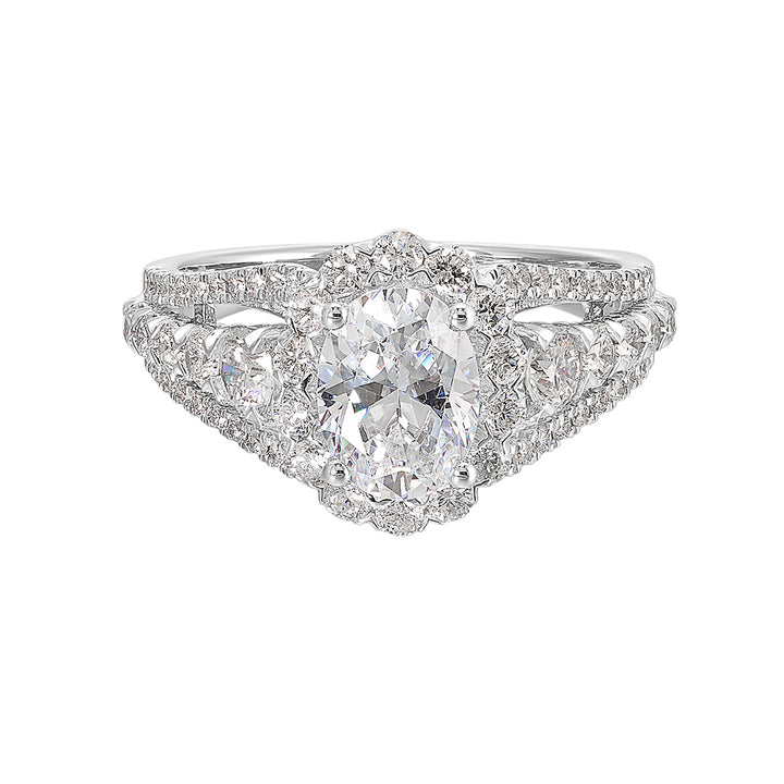 A dazzling broad ring with tapered shank consisting of bigger diamonds in the halo and center row complements her modern look.