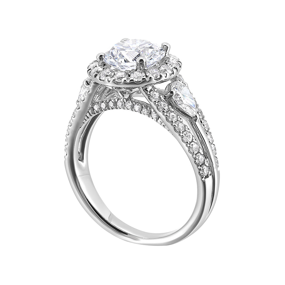 Start your love story with sparkles of this marquise and round diamond three stone engagement ring. The three rows shank have a beautiful split with pave studded diamonds on the sides.