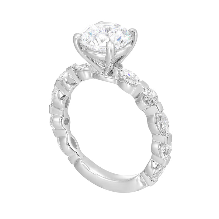 This engagement ring featues a sparkling round centre, with alternating marquise and round brilliant diamonds in the band.