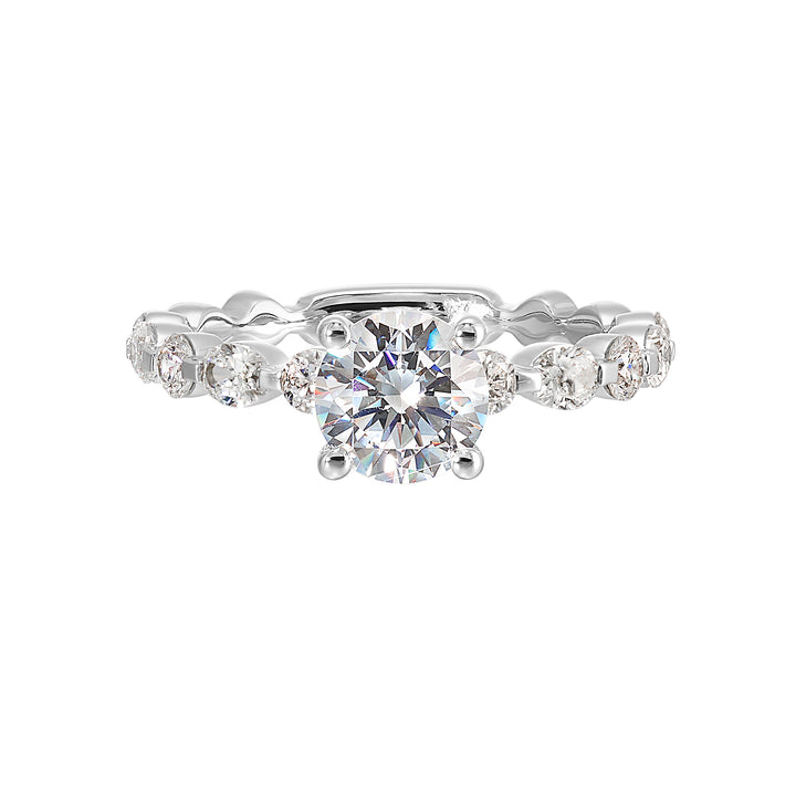 This trendy engagement ring features single prong diamonds set along the shank with stunning solitaire in center.
